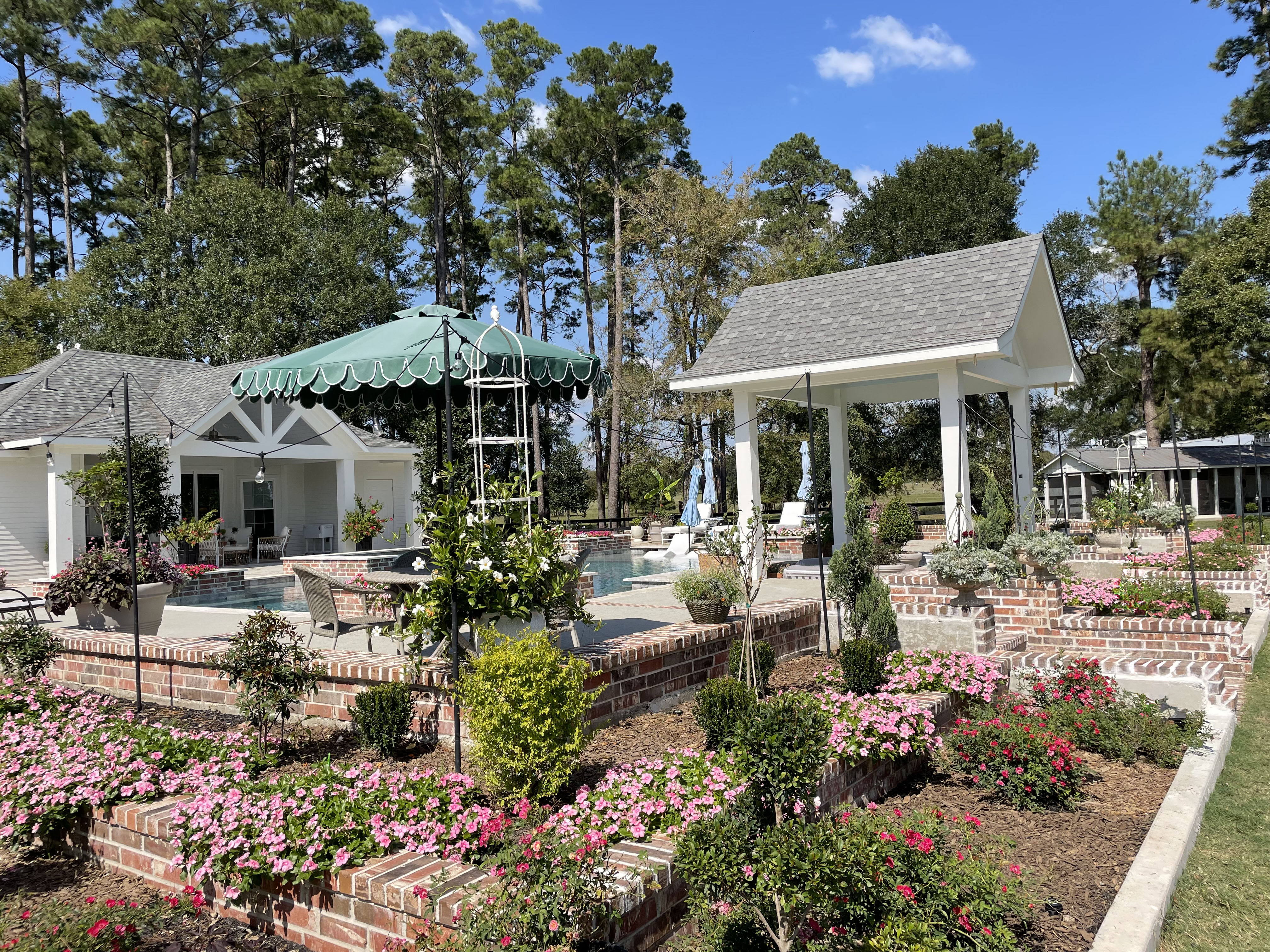 Seasonal landscape refresh with brick raised beds and flowering plants — New Yards Landscaping